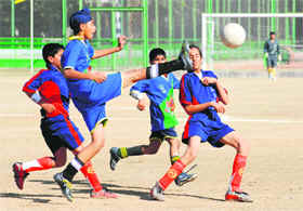 Players of St Johns and St Kabir in action during the final of St Kabir Football Trophy for Under-13 in Chandigarh on Wednesday.