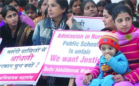 Parents under the banner of the Delhi Abhibhavak Mahasangh sit on dharna to protest against the admission procedure adopted by public schools for nursery class, at Jantar Mantar in New Delhi