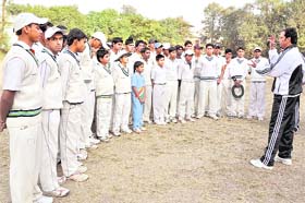 A coach explains finer tips of the game to participants of a cricket camp organised by the Uttarakhand Cricket Association