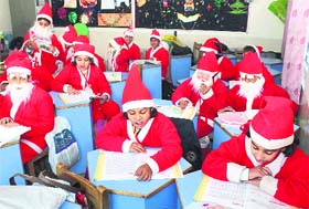 Little Santas: Children dressed as Santa Claus in a classroom at a school in Gurgaon