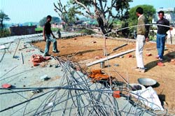 Labourers relay the roof of an under-construction building of Government Elementary School, Shahabpura, which collapsed