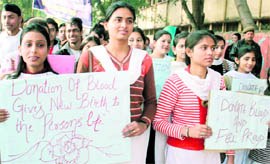 Students participate in an awareness rally for blood donation in Jammu on Wednesday
