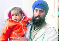 One-year-old Rozvin, who is being looked after by residents of Anandpur Sahib.The child lost her mother in an accident and her father is battling for life at the PGI, Chandigarh.