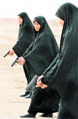 VEILED NO MORE: Iraqi policewomen train on weapons at the police academy in Najaf, 160 km of Baghdad, on Tuesday.