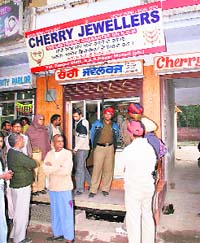 Police officials at the shop targeted by robbers at Dappar village, Lalru