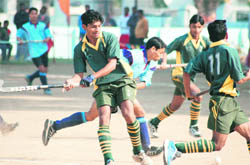 Players vie for the ball on the first day of the All-India Swami Shraddhanand Hockey Tournament in Haridwar.