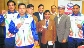Uttarakhand police chief Subhash Joshi (in cap) felicitates the policemen who won medals at the Commonwealth Powerlifting Championship held in Pune.