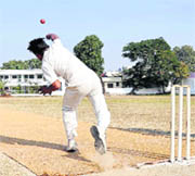 A bowler delivers a ball during a match of the 58th District Cricket League in Dehradun on Thursday.