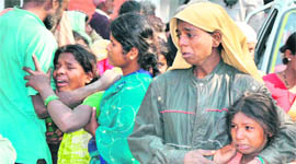 Kin of migrant labourers, who were killed in an accident at a construction site, mourn their death in Karnal on Thursday.