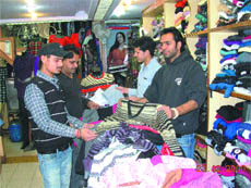 Customers select woollens at a shop in Jalandhar.
