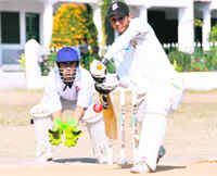 A batsman defends the ball in a match during the 58th District Cricket League in Dehradun on Friday.