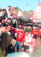 Members of the BJP offer milk to the Ganga to celebrate the birthday of former PM Atal Bihari Vajpayee in Haridwar on Friday. 