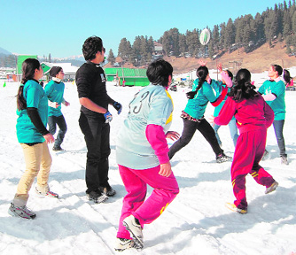 Tourists have fun at the snow festival in Gulmarg on Friday.