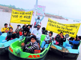 Greenpeace members make a noise for