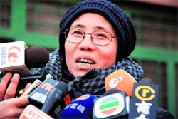 Liu Xiaobo, speaks to journalists at a law firm in Beijing on Friday. A Chinese court handed down a harsh 11-year sentence to the prominent dissident on subversion charges after he called for sweeping political reforms and an end to Communist Party dominance