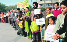 A human chain against the mild punishment given to Rathore at Sector 17, Chandigarh, on Saturday. 