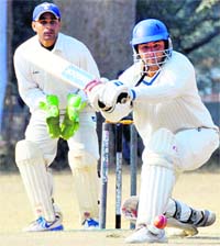 A batsman tries to play a sweep shot at the Beehive T20 Cricket Tournament in Dehradun