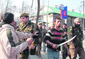 The police stops youths carrying swords at Dalgate in Srinagar