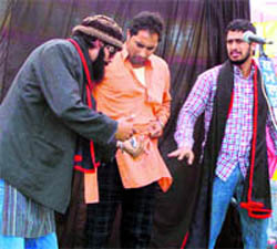 Artistes stage a play Shikhar Dopehere Hanera at Hassanpur village on Saturday