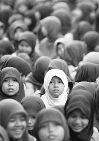 Acehnese students attend a mass prayer for friends who died in the 2004 Indian Ocean tsunami in Banda Aceh