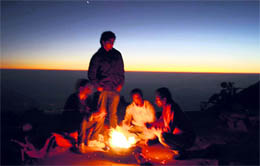 Youths light a bonfire to beat the chill at McLeodganj on Sunday.
