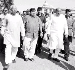 BJP president Nitin Gadkari (centre) walks with officials as he visits RSS headquarters in Mumbai on Sunday.
