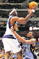 Dallas Mavericks forward Josh Howard (L) is fouled by Memphis Grizzlies forward Rudy Gay during the second half of their NBA basketball game in Dallas on Saturday.
