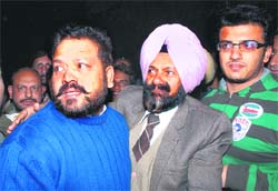 Davinder Singh Babla, flanked by his family members and supporters, outside the Sector 24 police post in Chandigarh on Monday night before surrendering to the police