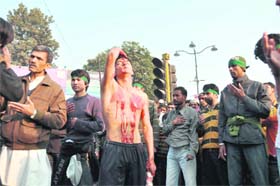 A mourner with blood on his body while performing matam at a Moharram procession in Dehradun