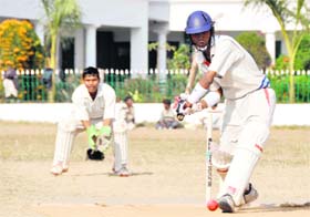 A batsman takes on a delivery in a match during the District Cricket League in Dehradun