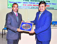 The chief guest (right) being honoured at a seminar held at ICFAI University in Dehradun on Monday