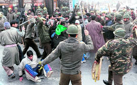 Policemen clash with Shia mourners during a Muharram procession in Srinagar on Monday. 