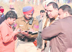Ashok Kumar (left) with the police;
