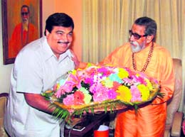BJP president Nitin Gadkari presents a bouquet to Shiv Sena chief Bal Thackeray in Mumbai on Monday. 