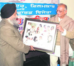 Vice-Chancellor of Punjabi University Dr Jaspal Singh honours filmmaker, scriptwriter and Oscar-winning lyricist Gulzar at a function on the university campus in Patiala on Monday.