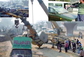 The crane which fell on some cars from a flyover construction site near Badarpur in New Delhi on Tuesday morning is carried away