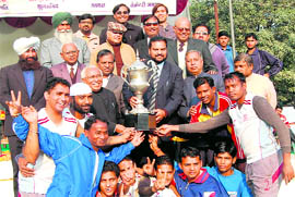BEG-Rorkee team members receive the trophy after winning the All-India Swami Shraddhanand Hockey Tournament in Haridwar on Tuesday