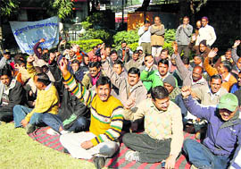 MDDA employees stage a dharna in Dehradun on Tuesday