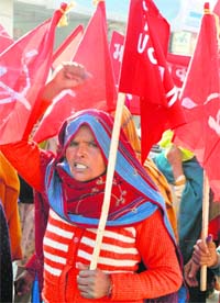 A CPM activist holds protest against price rise in Karnal