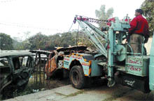 A recovery van dumps scrap in the park of PUDA complex in Jalandhar.