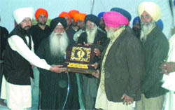 Members of the Guru Teg Bahadur Welfare Society honour former Akal Takht Jathedar Prof Darshan Singh at Palahi village in Phagwara on Tuesday evening.