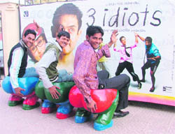 Young boys pose before a poster of Three Idiots outside a cinema hall in Ludhiana.