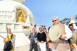Bihar Chief Minister Nitish Kumar beats the holy drum as part of a ritual near the historical Shanti Stupa, before convening a Cabinet meeting,