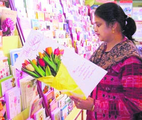 A customer selects New Year greeting cards in a shop in Bathinda on Tuesday.