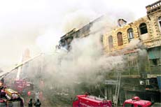 Pakistani firefighters struggle to control the fire in a Karachi market on Tuesday. 