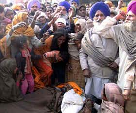 Family members of the victim protest against the police keeping the body in middle of the road in Ajnala on Wednesday.