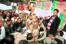 BJP activists protest against the report of Justice Sagir Ahmed (retd) outside the Raj Bhawan in Jammu on Wednesday