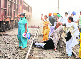 Roit victims pelt a train with stones at a level crossing near Gyaspura.