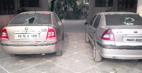Broken glass of the two cars parked at the residence of Inderjit Singh.