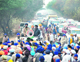 Members of Gurmati Sidhant Parcharak Sant Samaj block a road after the police stop them at Sawara, near Landran, while they were protesting over the recent Sikh killings in Ludhiana.